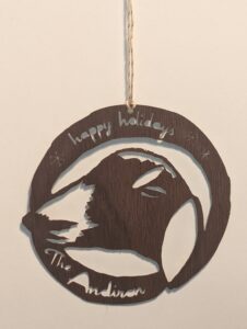 wooden ornament featuring goat